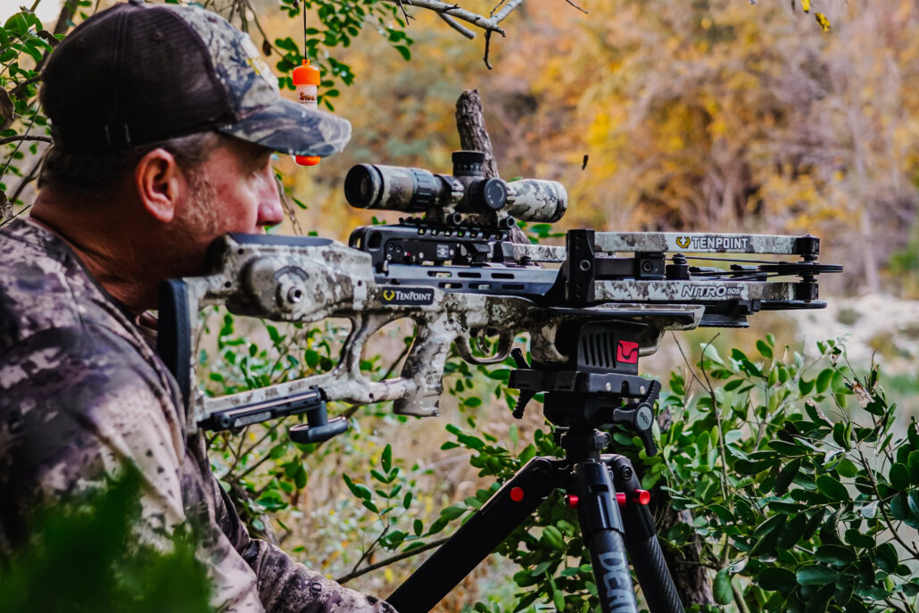 Crossbow mounted on shooting sticks