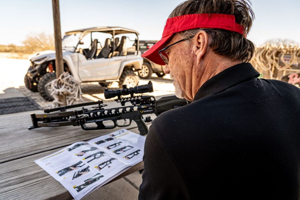 Man reading directions for crossbow