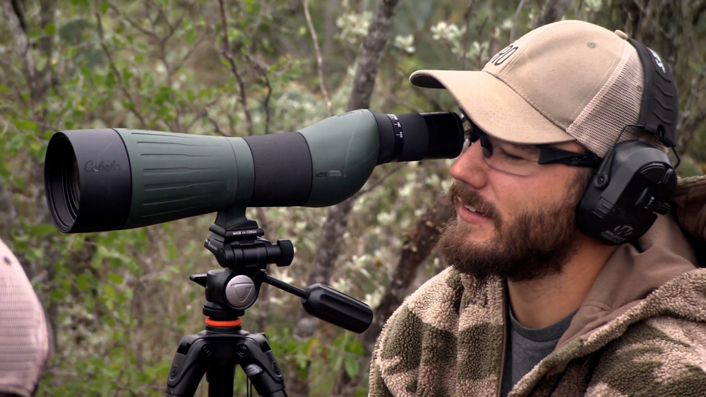 Hunter looking through spotting scope