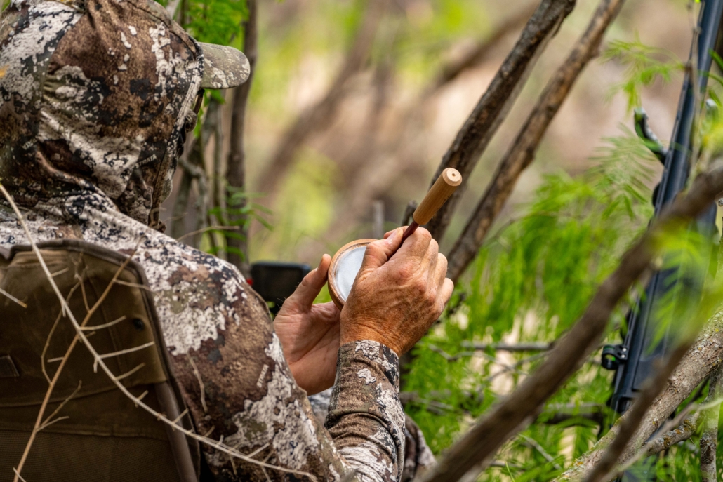 hunter using a turkey hunting call
