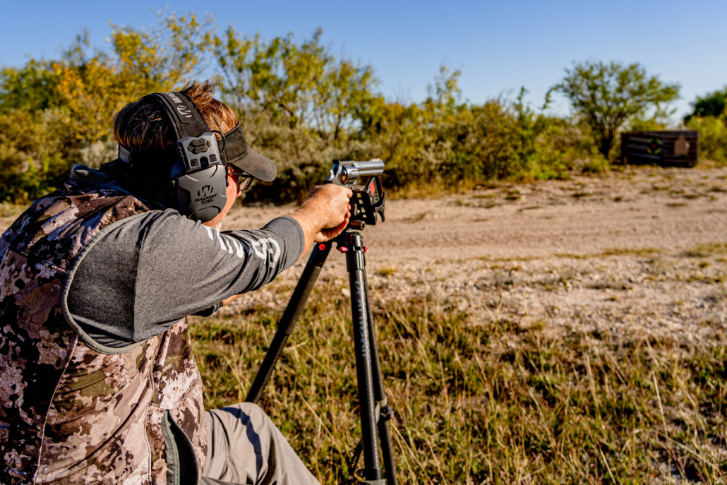 man aiming handgun on gun range